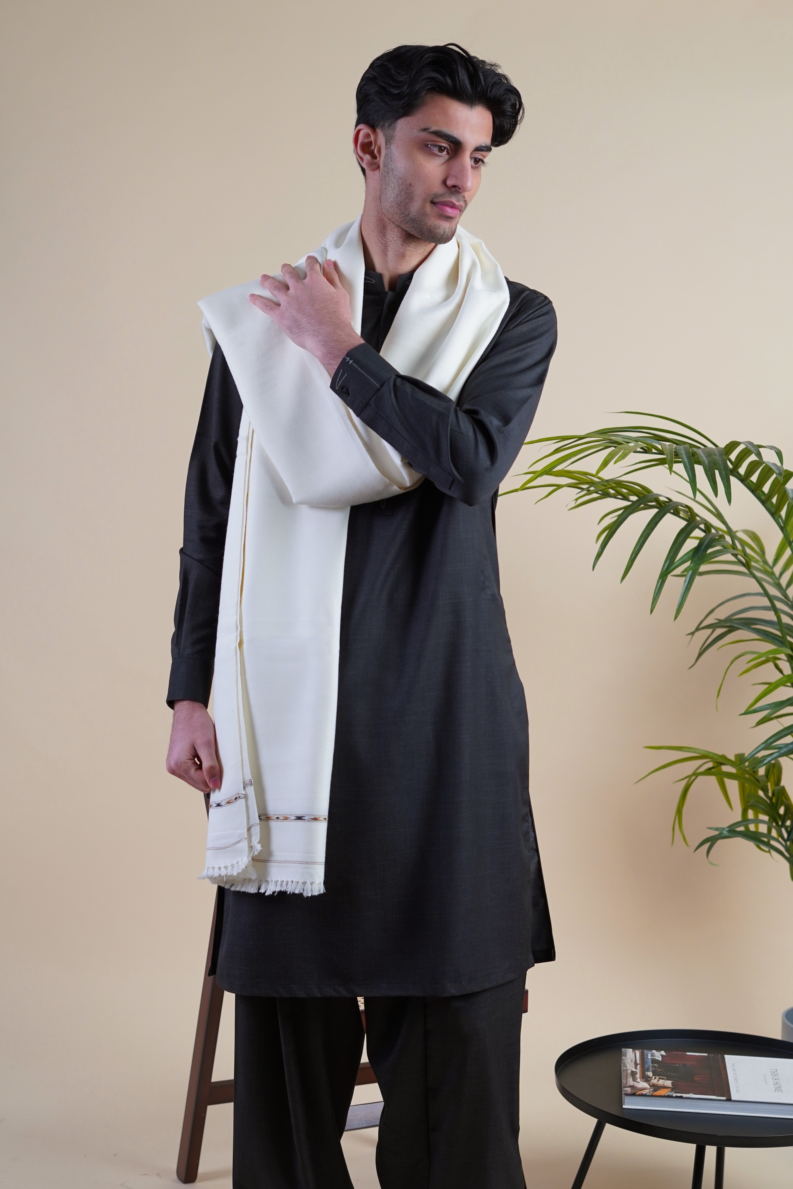 Pakistani male model wearing UD Fabrics black shalwar kameez and off white shawl
